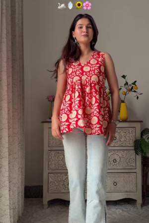 Women’s Sleeveless Red Floral Top with Light Blue Flared Jeans – Indo-Western Casualwear Styled with Vintage Decor Backdrop