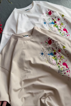 Unisex White & Beige T-Shirts with Colorful Paint Splatter and Pocket Embroidery – Artistic Casualwear for Everyday Styling